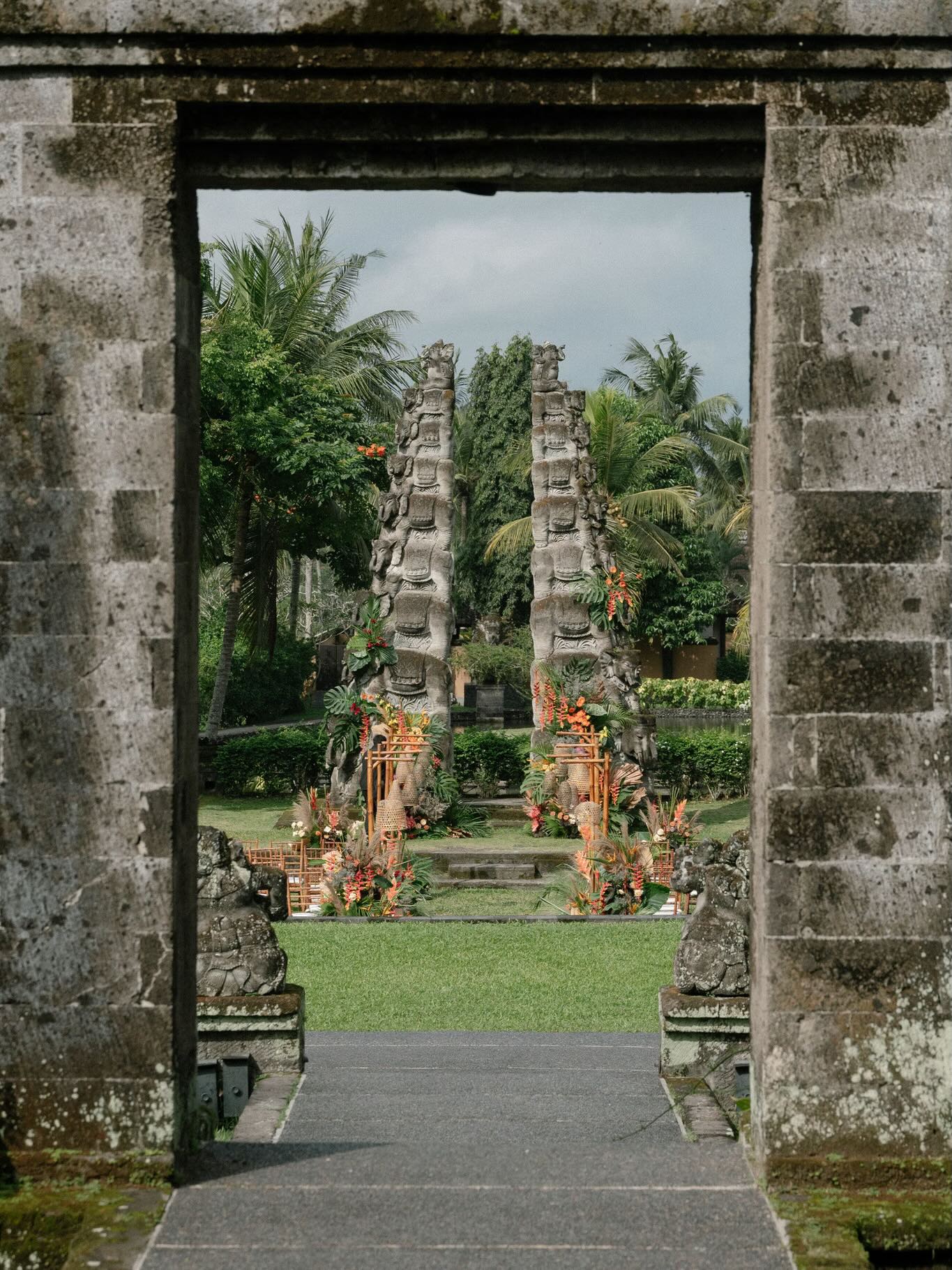 Balinese gate framed by tropical floral wedding decoration