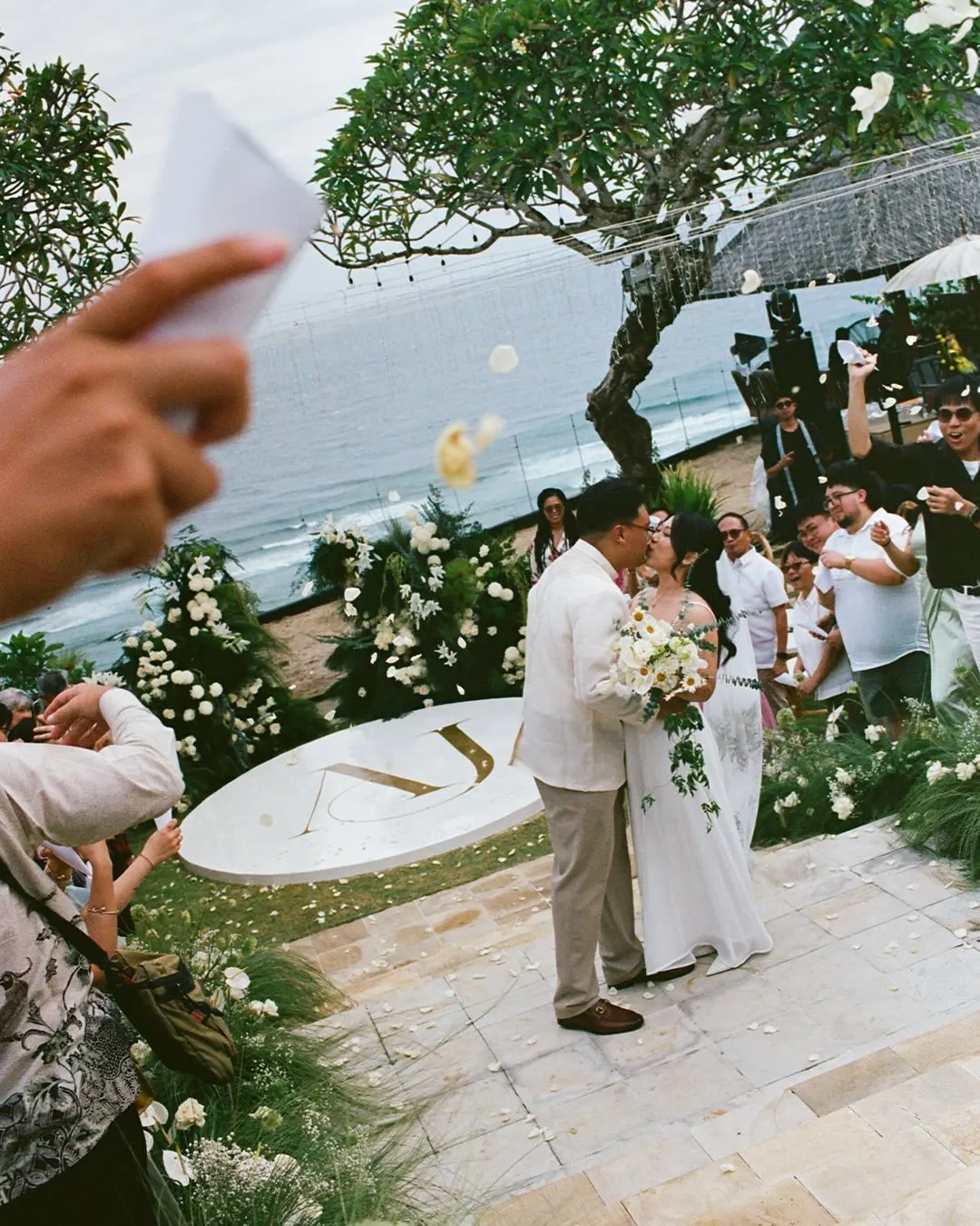 White floral decoration at a beachfront wedding ceremony